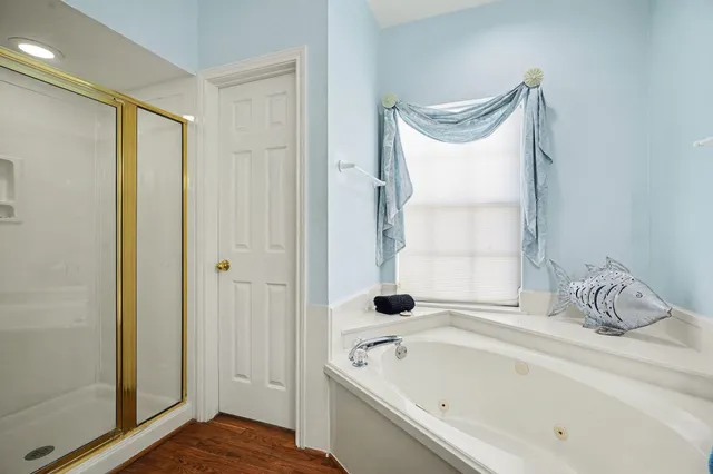a spacious bathroom with a double vanity sink and a mirror