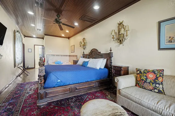 a bedroom with furniture and a rug