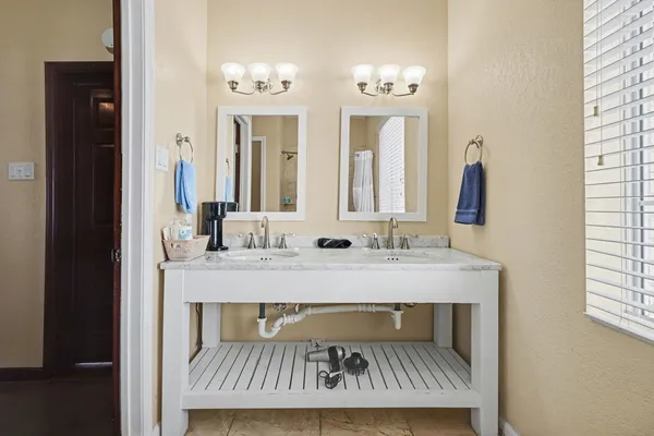 a view of bathroom with dual sinks