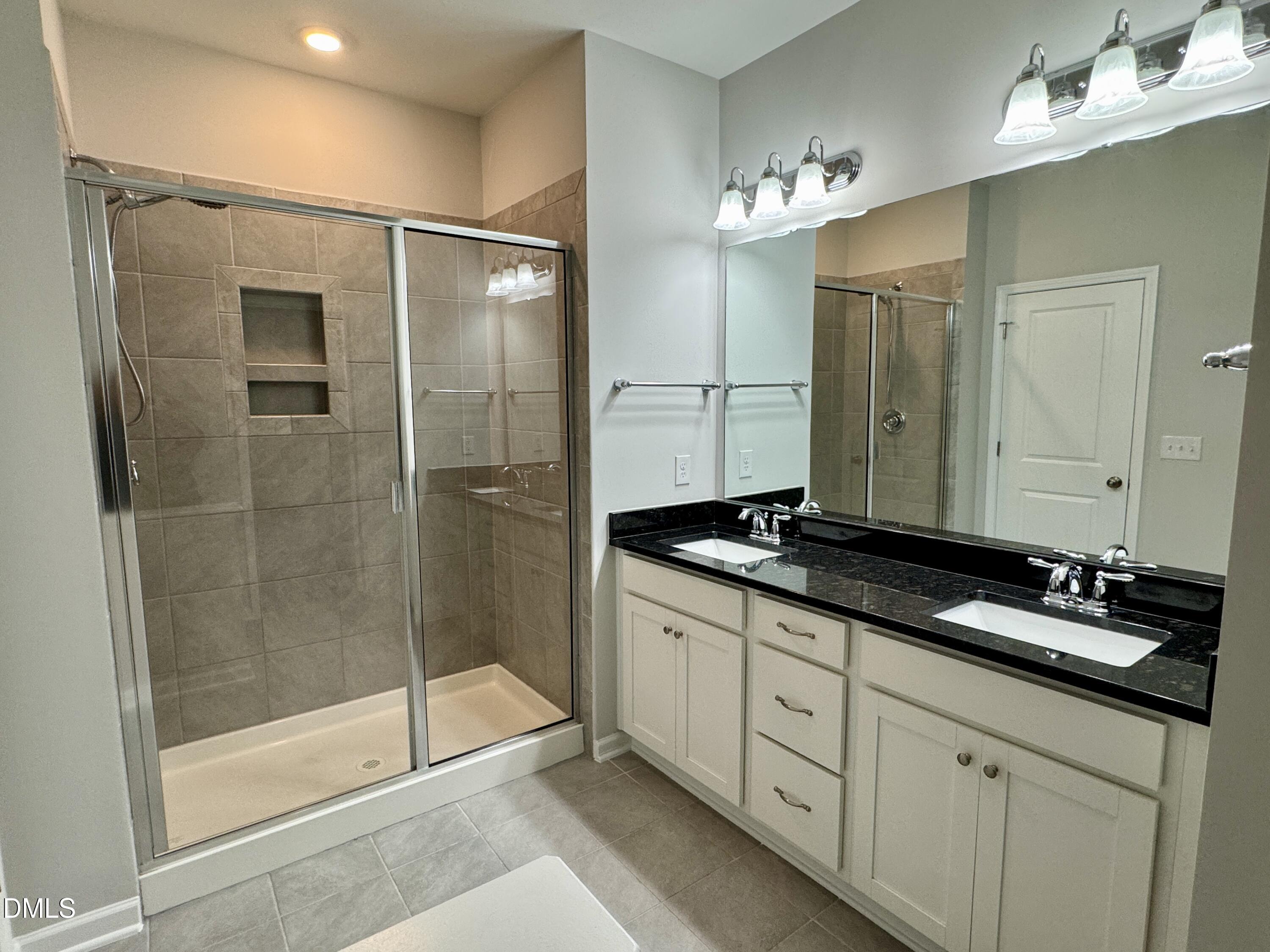 136 Durie Way Garner, NC 27529 - Photo 14 of 30 a bathroom with a double vanity sink and mirror