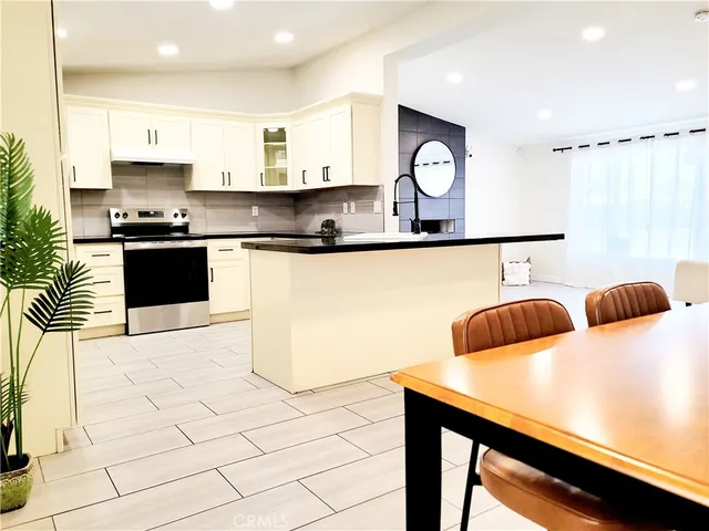 a kitchen with stainless steel appliances and cabinets