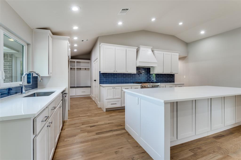 3161 Lockmoor Lane Dallas, TX 75220 - Photo 10 of 25 a kitchen with kitchen island granite countertop a sink a stove and cabinets