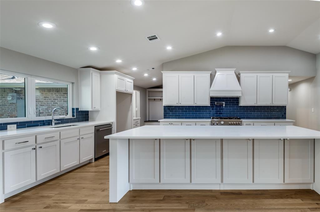 3161 Lockmoor Lane Dallas, TX 75220 - Photo 13 of 25 a large kitchen with stainless steel appliances a large counter top a stove and a refrigerator