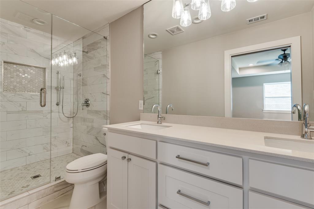 3161 Lockmoor Lane Dallas, TX 75220 - Photo 17 of 25 a bathroom with a sink a toilet and shower