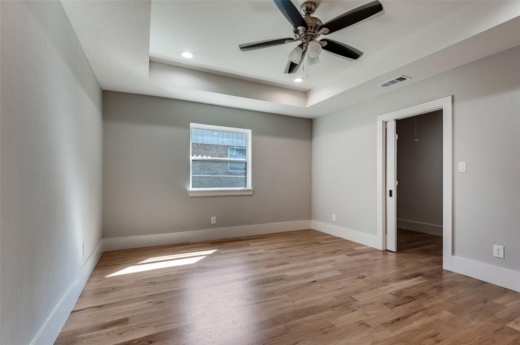 3161 Lockmoor Lane Dallas, TX 75220 - Photo 18 of 25 an empty room with wooden floor and windows