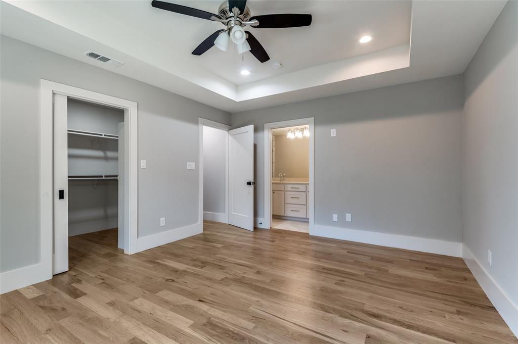 3161 Lockmoor Lane Dallas, TX 75220 - Photo 19 of 25 an empty room with wooden floor cabinet and windows