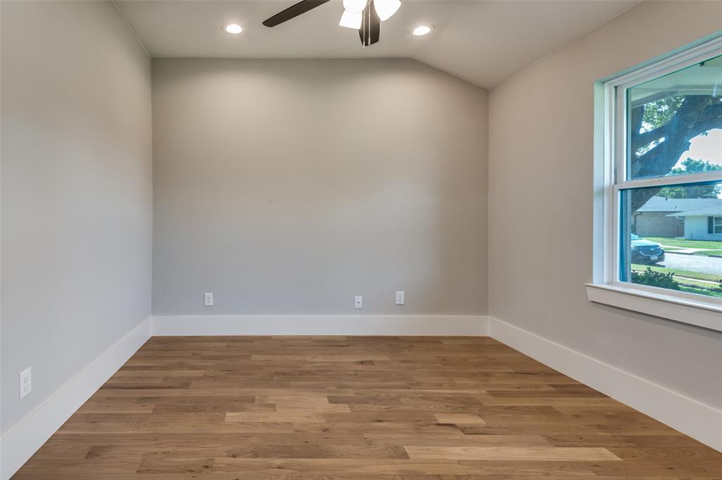 3161 Lockmoor Lane Dallas, TX 75220 - Photo 20 of 25 a view of an empty room with wooden floor and a window