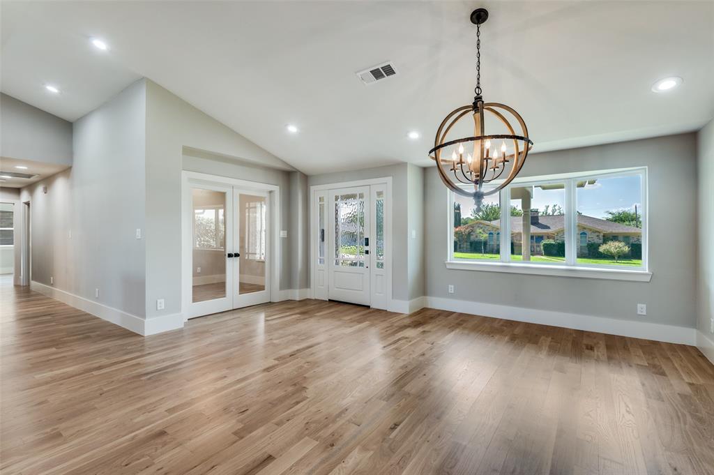 3161 Lockmoor Lane Dallas, TX 75220 - Photo 4 of 25 a view of an empty room with wooden floor and window