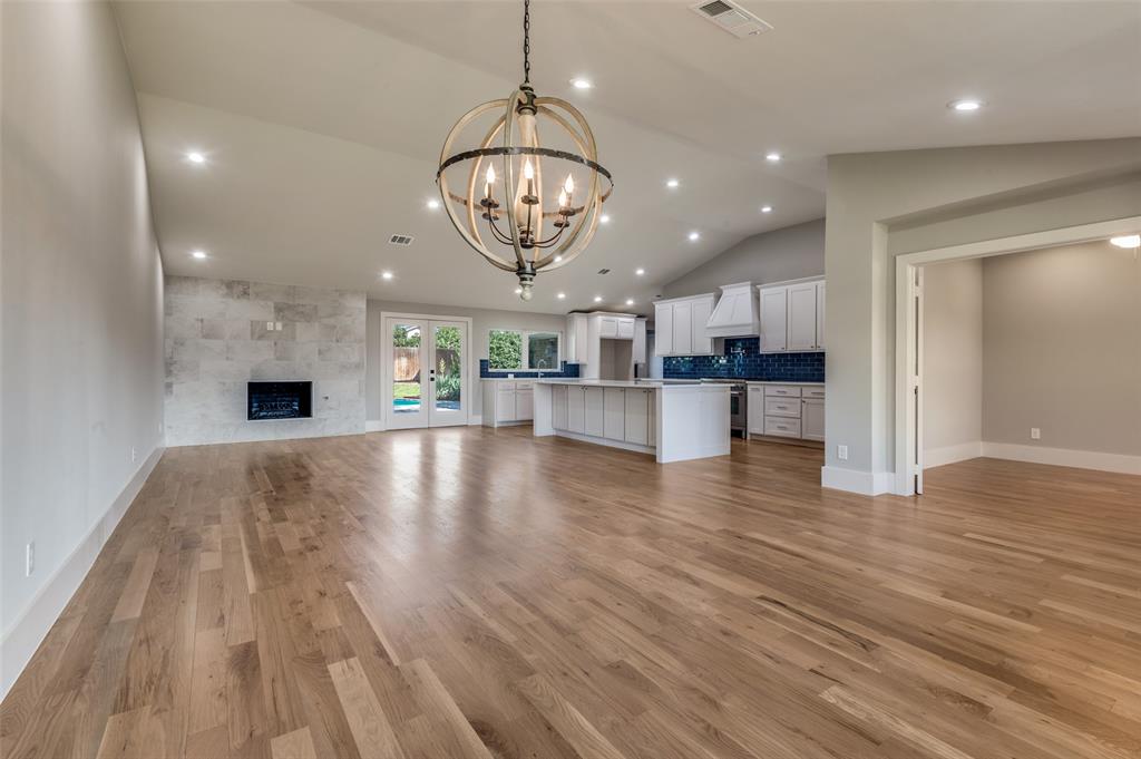 3161 Lockmoor Lane Dallas, TX 75220 - Photo 7 of 25 a view of a kitchen and an empty room with wooden floor