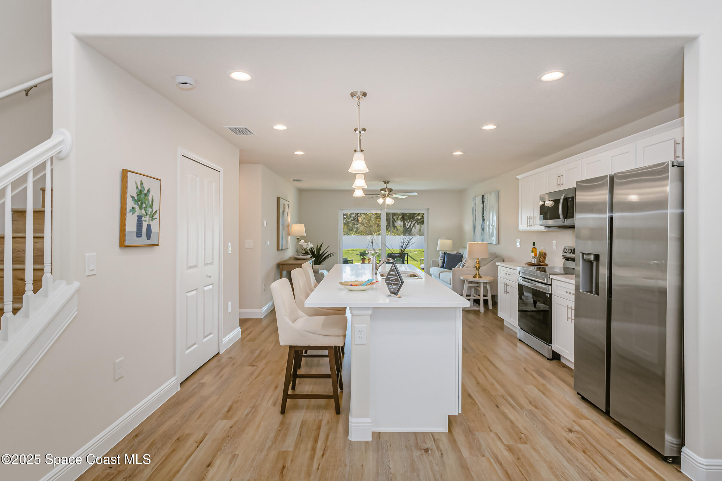 187 Hidden Woods Place Melbourne, FL 32901 - Photo 12 of 40 a view of a kitchen with dining table and stainless steel appliances