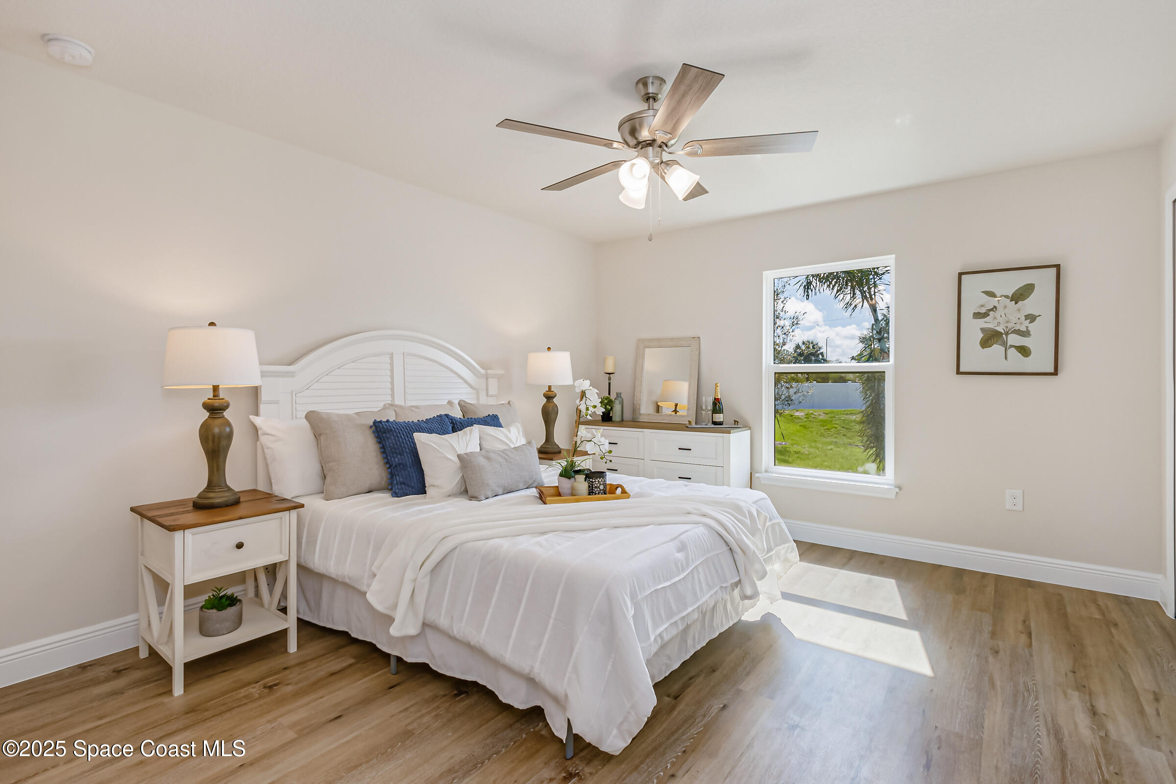 187 Hidden Woods Place Melbourne, FL 32901 - Photo 14 of 40 a bedroom with a bed a couch and a window