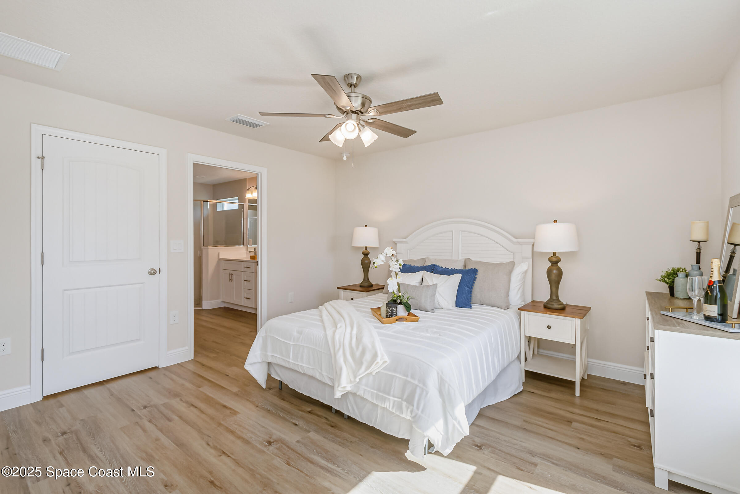 187 Hidden Woods Place Melbourne, FL 32901 - Photo 15 of 40 a bedroom with a bed and a chandelier