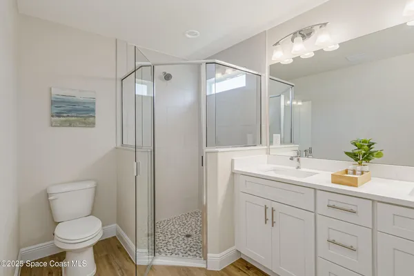 a bathroom with a toilet sink and shower