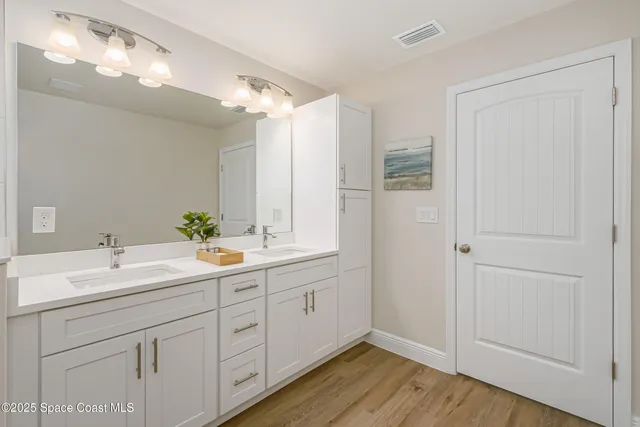 a bathroom with a double vanity sink and mirror