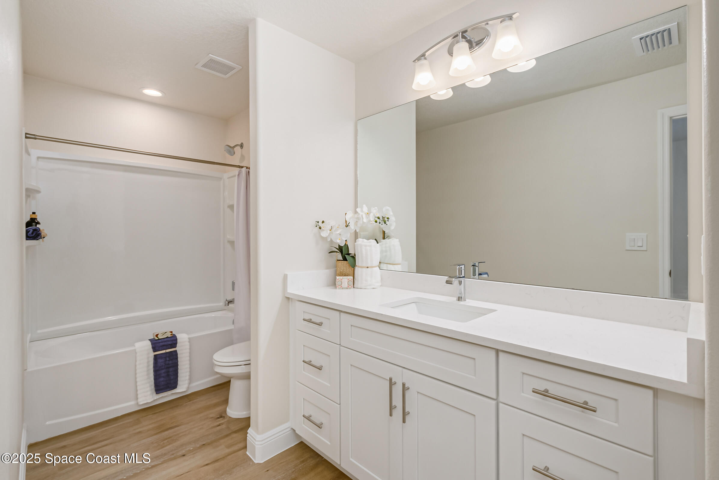 187 Hidden Woods Place Melbourne, FL 32901 - Photo 21 of 40 a bathroom with a double vanity sink a toilet and shower