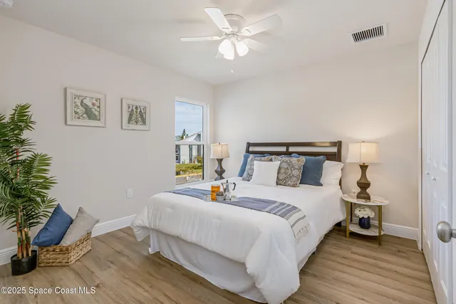 a bedroom with bed and a potted plant
