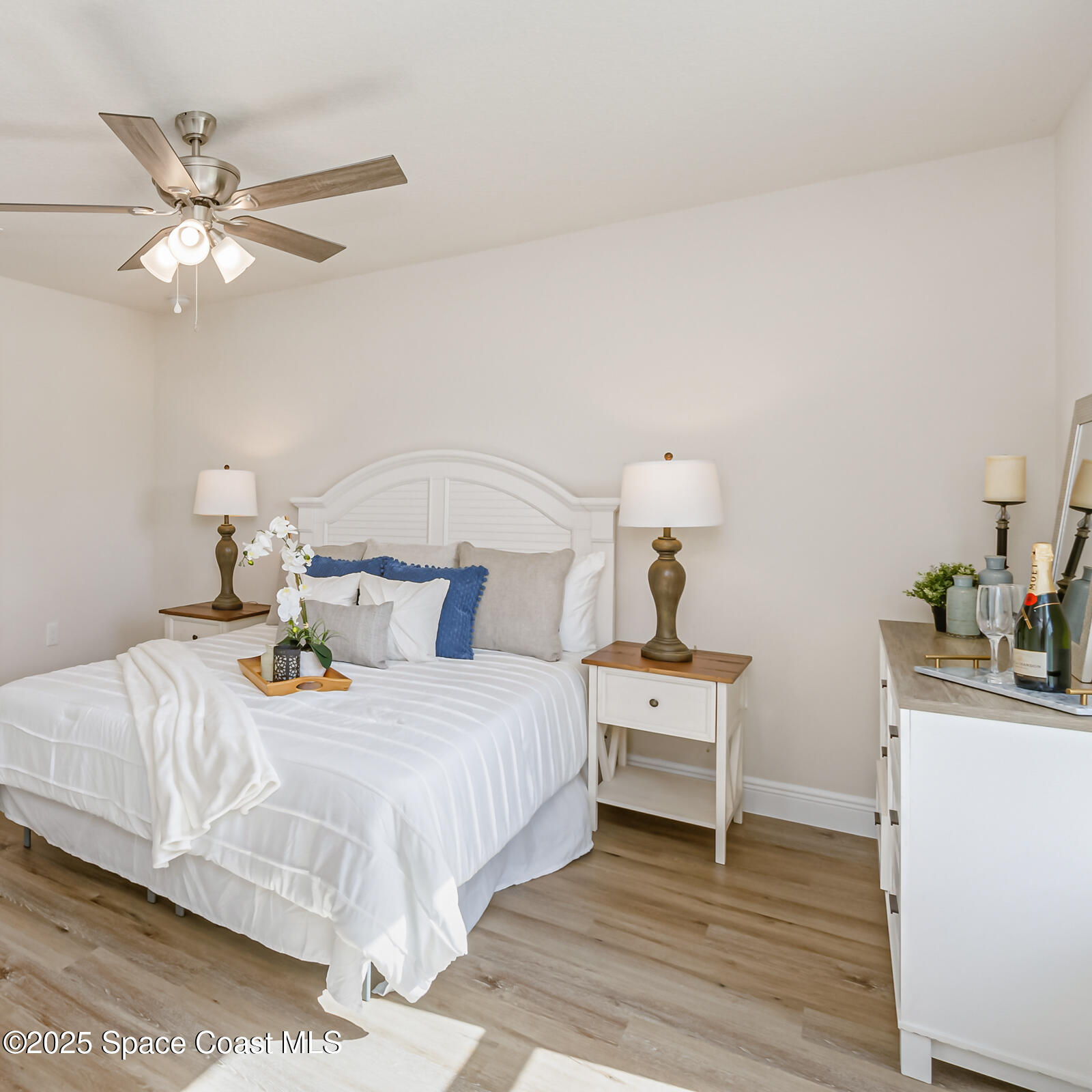187 Hidden Woods Place Melbourne, FL 32901 - Photo 29 of 40 a bedroom with a bed and wooden floor