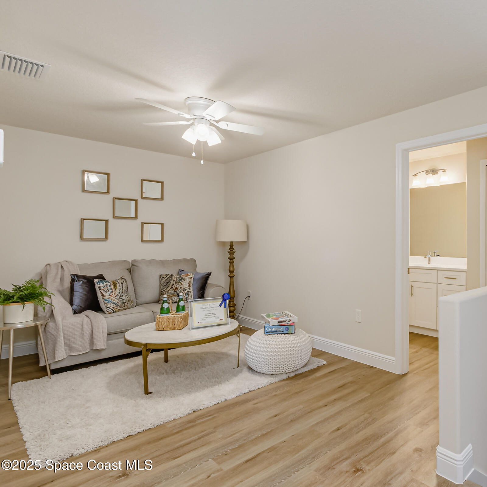 187 Hidden Woods Place Melbourne, FL 32901 - Photo 31 of 40 a living room with furniture and a wooden floor