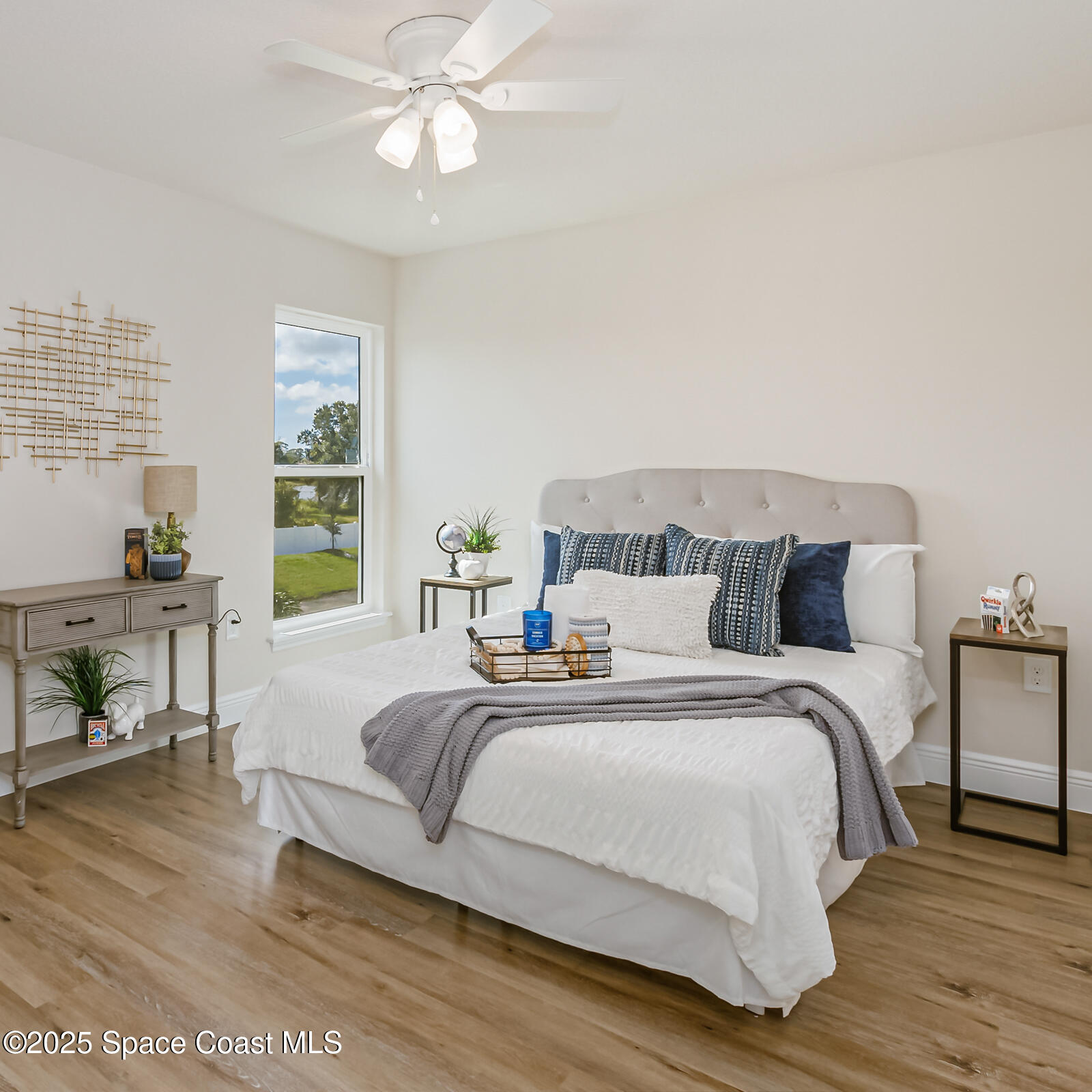 187 Hidden Woods Place Melbourne, FL 32901 - Photo 34 of 40 a bedroom with bed and a chandelier