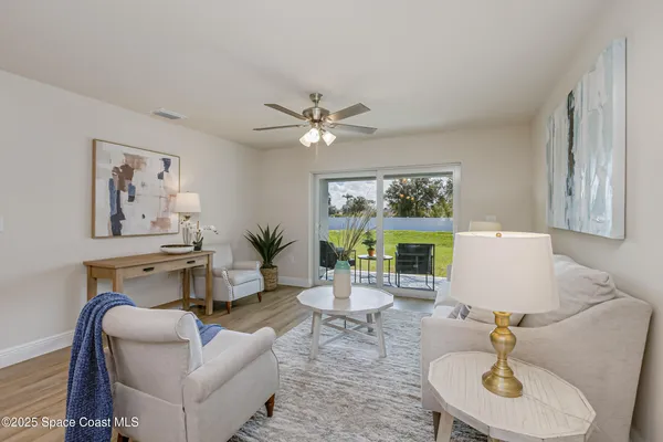 a living room with furniture a window and a chandelier