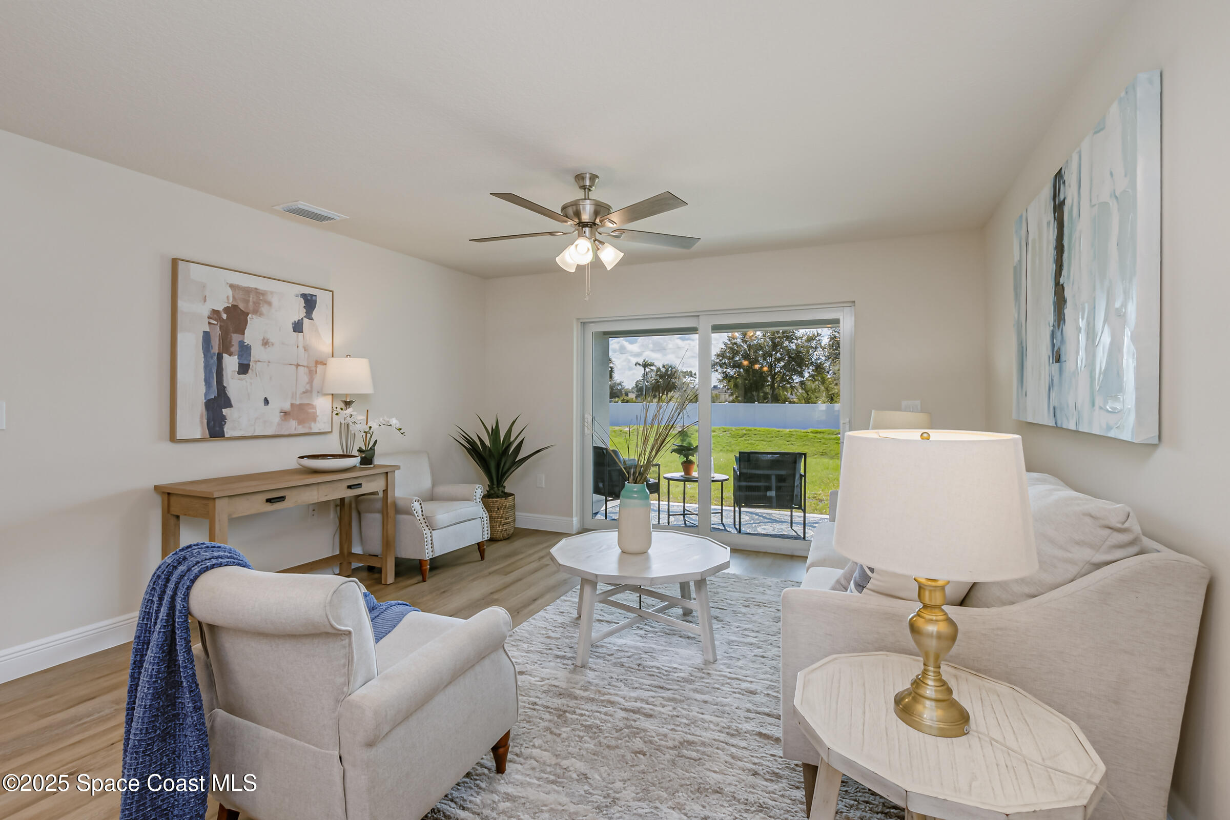 187 Hidden Woods Place Melbourne, FL 32901 - Photo 4 of 40 a living room with furniture a window and a chandelier