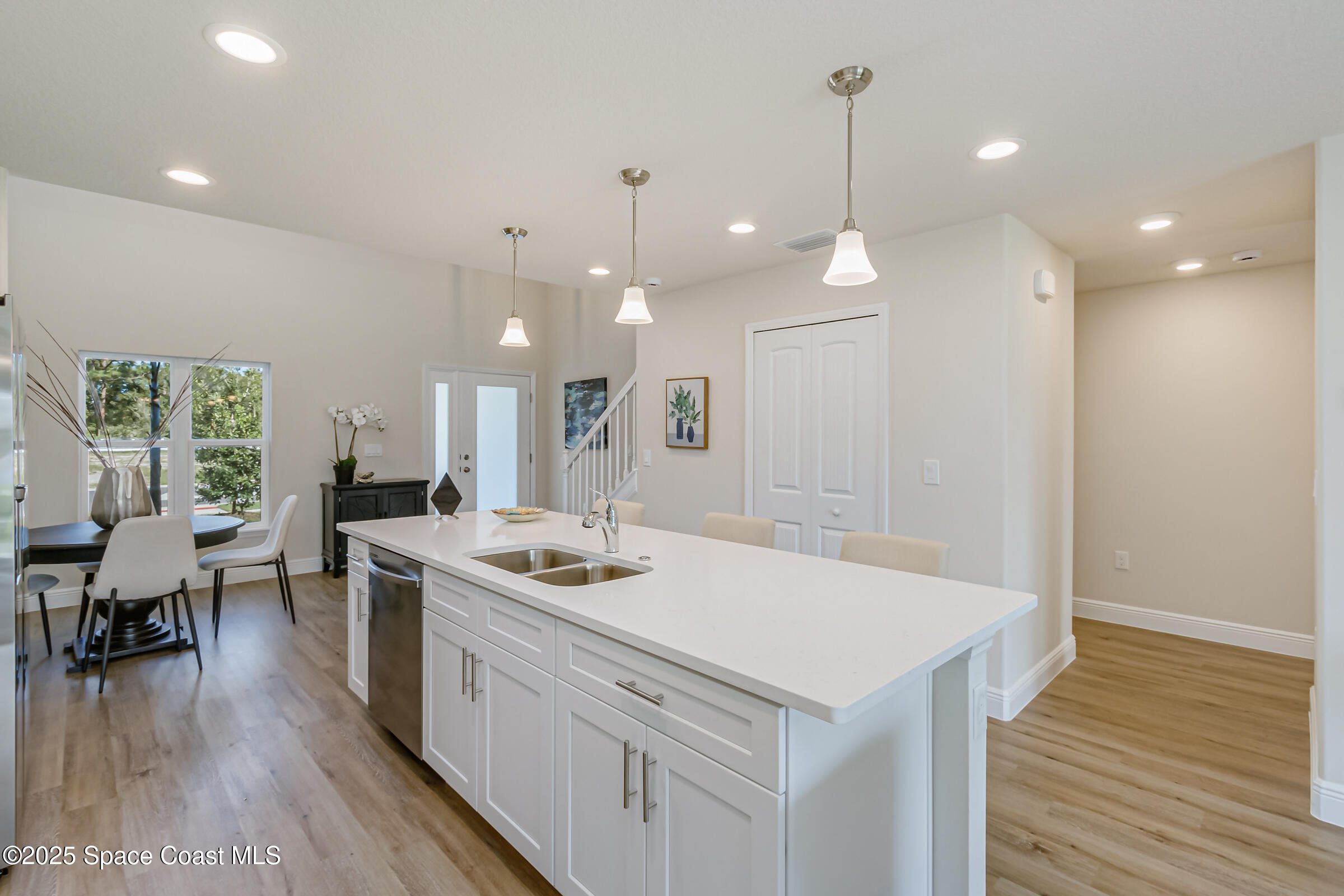 187 Hidden Woods Place Melbourne, FL 32901 - Photo 7 of 40 a kitchen that has a lot of cabinets a sink and wooden floor