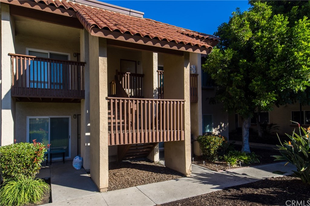 a view of a house with porch and plants