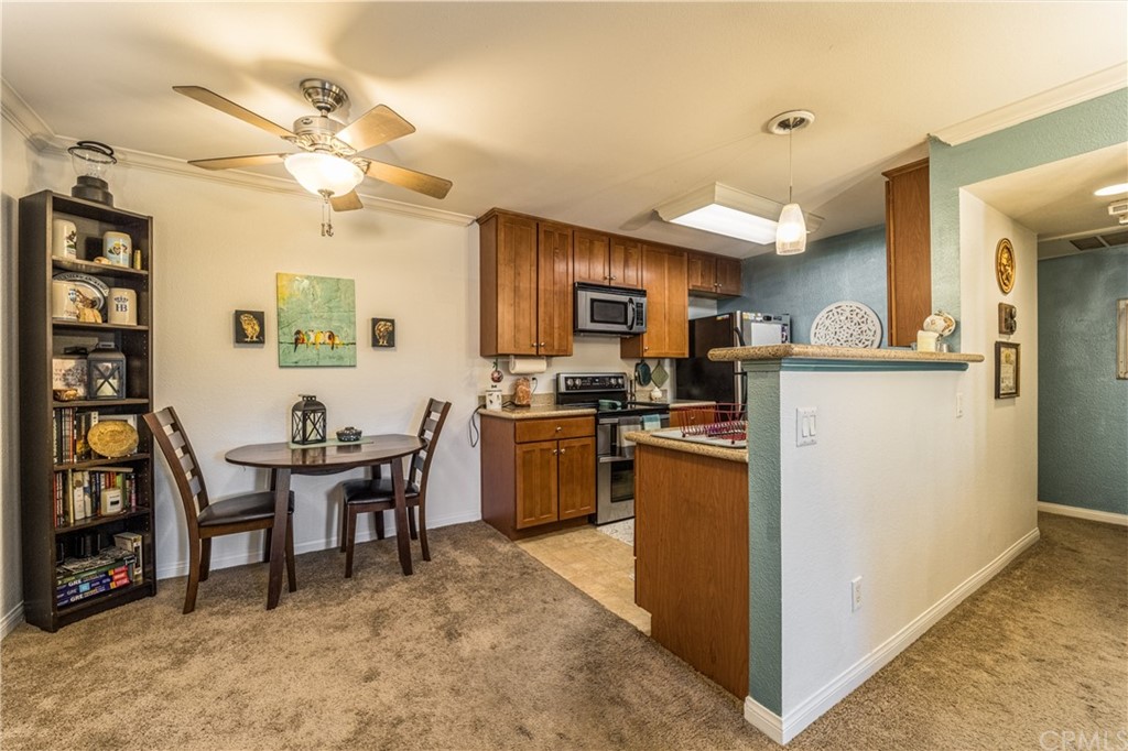 180 Chambers Street, Unit 28 El Cajon, CA 92020 - Photo 12 of 22 a kitchen with a refrigerator a stove top oven a dining table and chairs