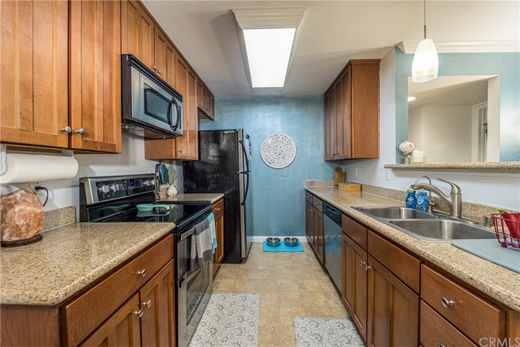 180 Chambers Street, Unit 28 El Cajon, CA 92020 - Photo 9 of 22 a kitchen with stainless steel appliances granite countertop a sink stove and cabinets