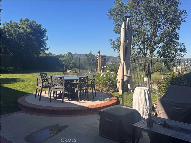 a view of a chairs and table in patio