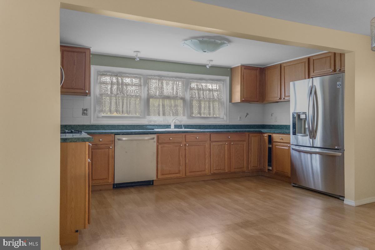 155 Locust Avenue Hamilton, NJ 08610 - Photo 6 of 25 a kitchen with granite countertop stainless steel appliances a sink and a refrigerator