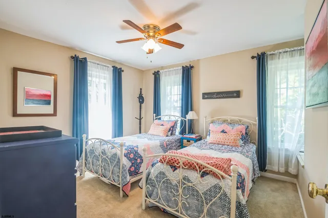 a bedroom with two beds and a chandelier
