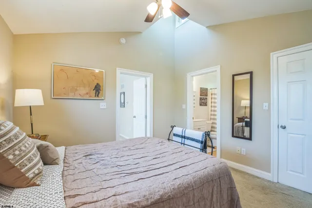 a bedroom with a bed and a lamp