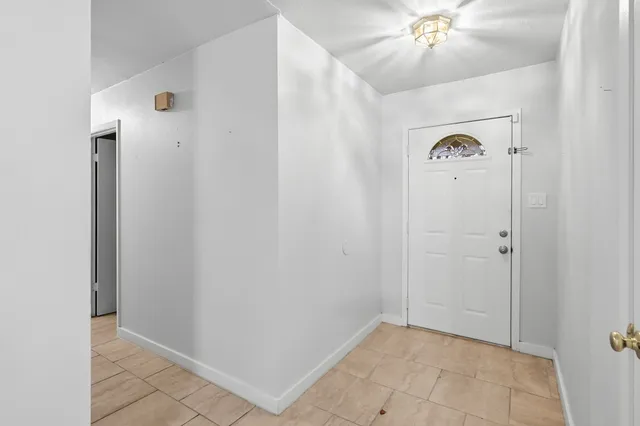 a view of an empty room with a fireplace