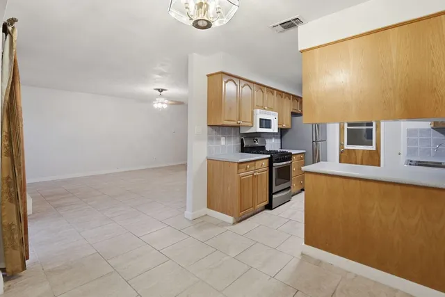 a kitchen with a sink stove and cabinets