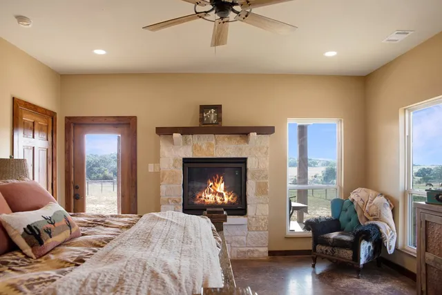 a bedroom with a bed and a fireplace