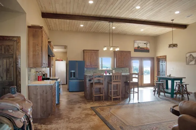 a dining room with lots of furniture and chandelier