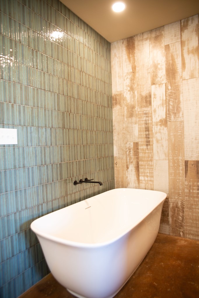 4252 Cypress Mill Road Johnson City, TX 78636 - Photo 20 of 47 a white bath tub sitting in a bathroom