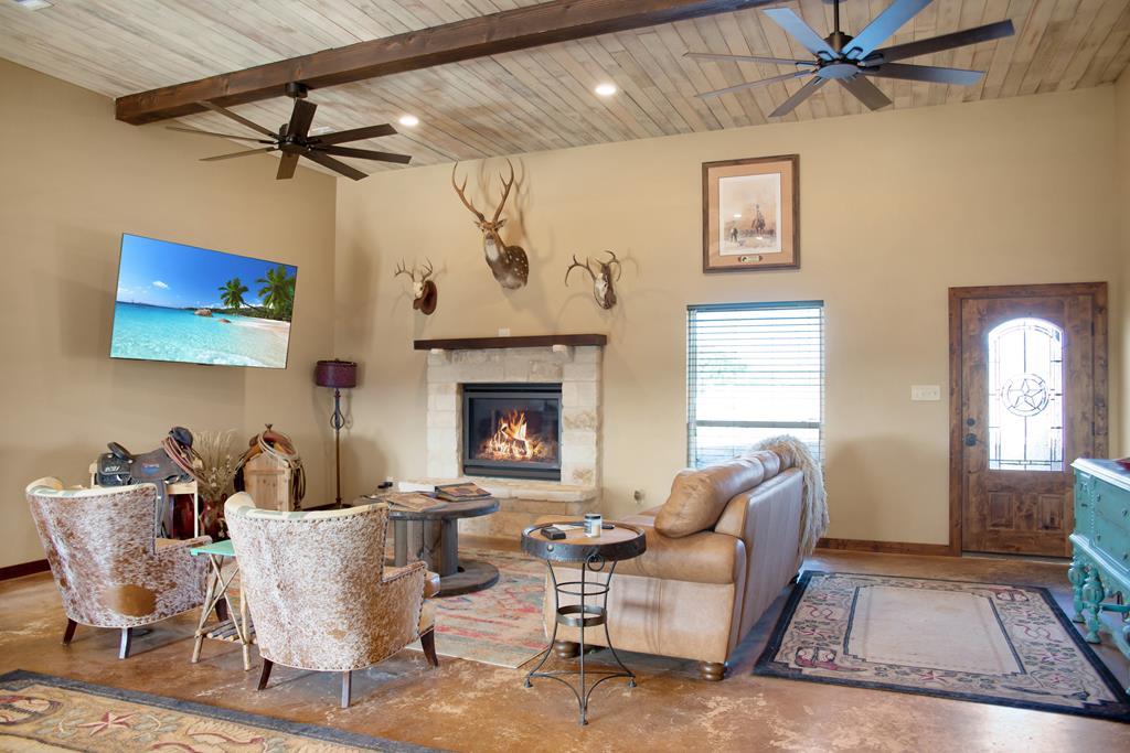 4252 Cypress Mill Road Johnson City, TX 78636 - Photo 2 of 47 a living room with furniture and a fireplace