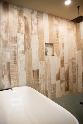 a bedroom with a bed and a large mirror