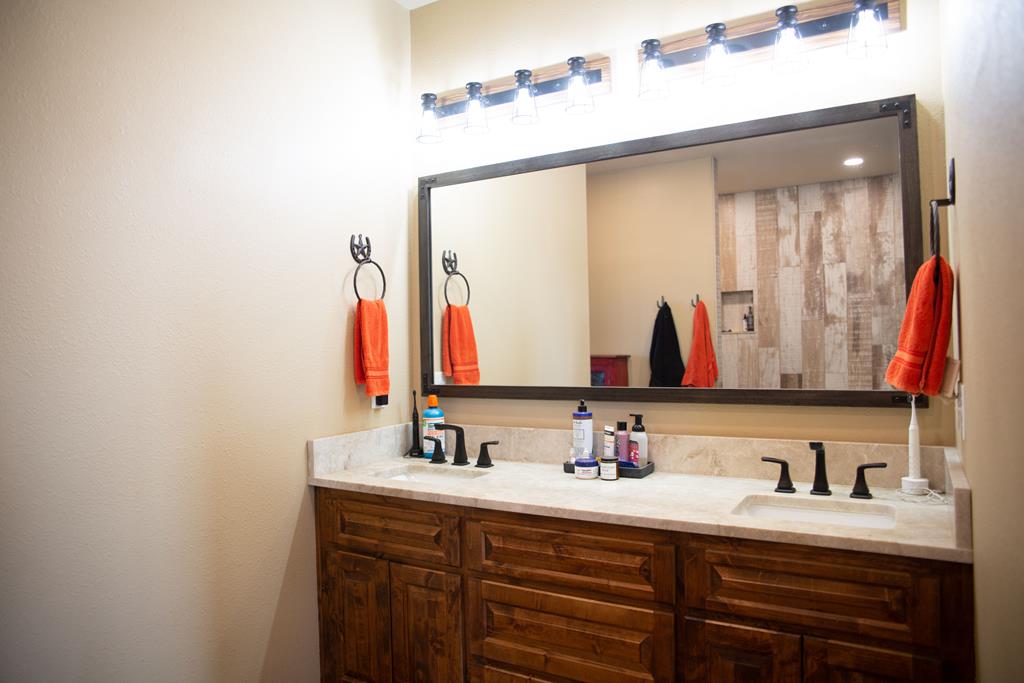 4252 Cypress Mill Road Johnson City, TX 78636 - Photo 23 of 47 a bathroom with a double vanity sink and a mirror