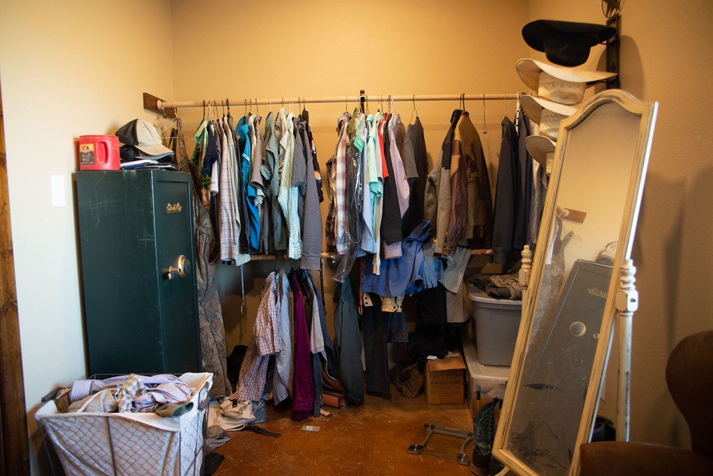 4252 Cypress Mill Road Johnson City, TX 78636 - Photo 24 of 47 a view of walk in closet with clothes and shoes