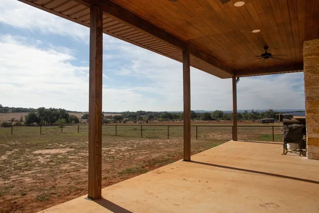 a bathroom with a tub shower and mirror