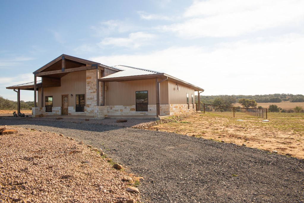 4252 Cypress Mill Road Johnson City, TX 78636 - Photo 7 of 47 a big house with a big yard and large trees