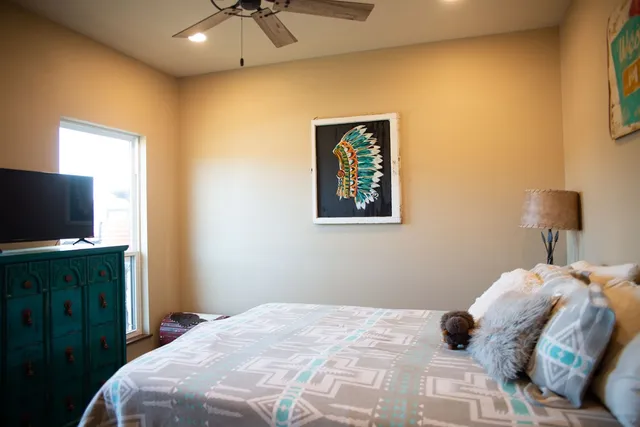 a bedroom with a bed and a flat screen tv