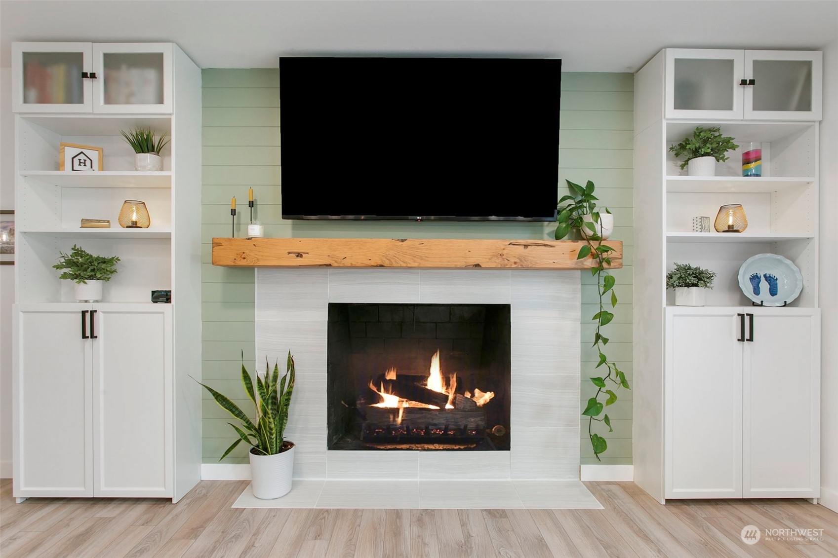 205 155th Place Southeast Bothell, WA 98012 - Photo 11 of 37 a living room with a fireplace and a flat screen tv