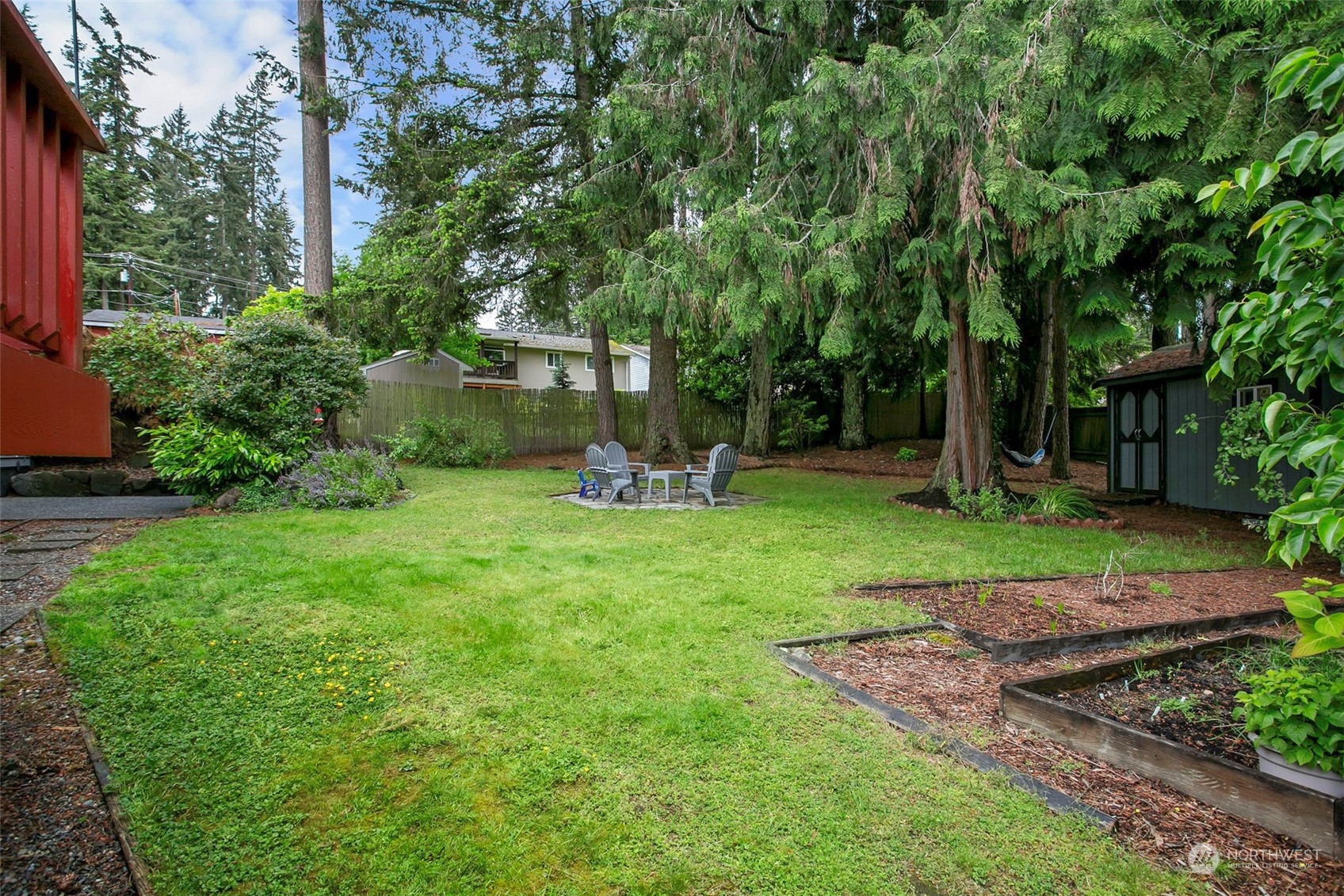 205 155th Place Southeast Bothell, WA 98012 - Photo 24 of 37 a view of a table and chairs in backyard of the house