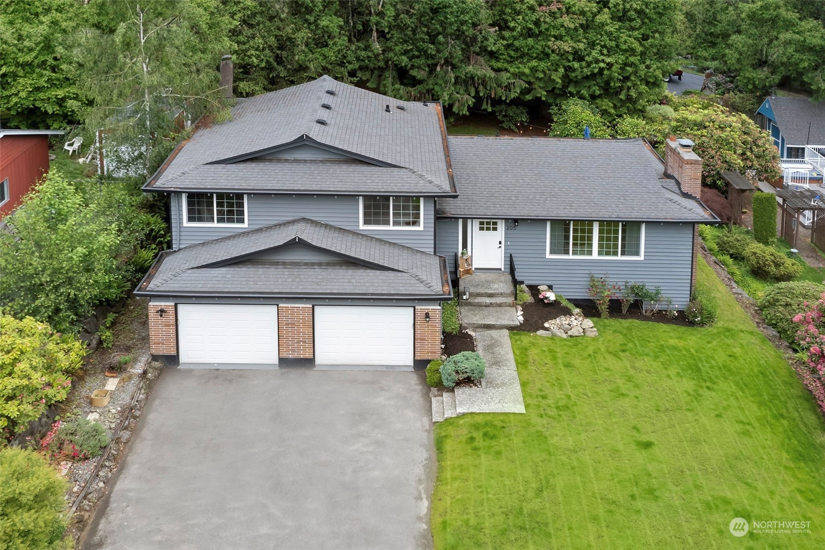 205 155th Place Southeast Bothell, WA 98012 - Photo 34 of 37 a front view of a house with garden