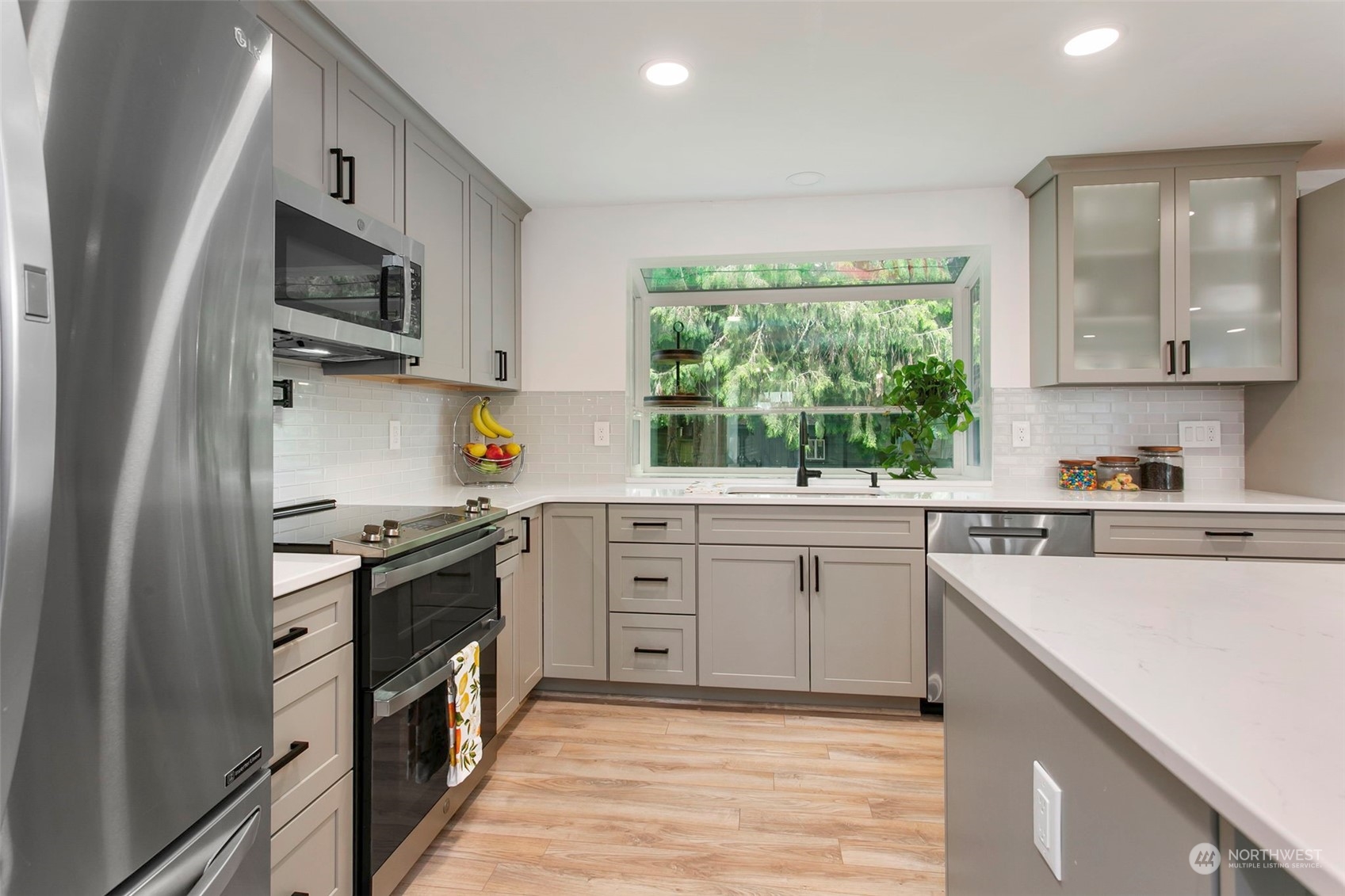 205 155th Place Southeast Bothell, WA 98012 - Photo 9 of 37 a kitchen with stainless steel appliances granite countertop a stove a sink and a microwave