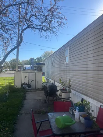 a view of a backyard with plants and outdoor seating